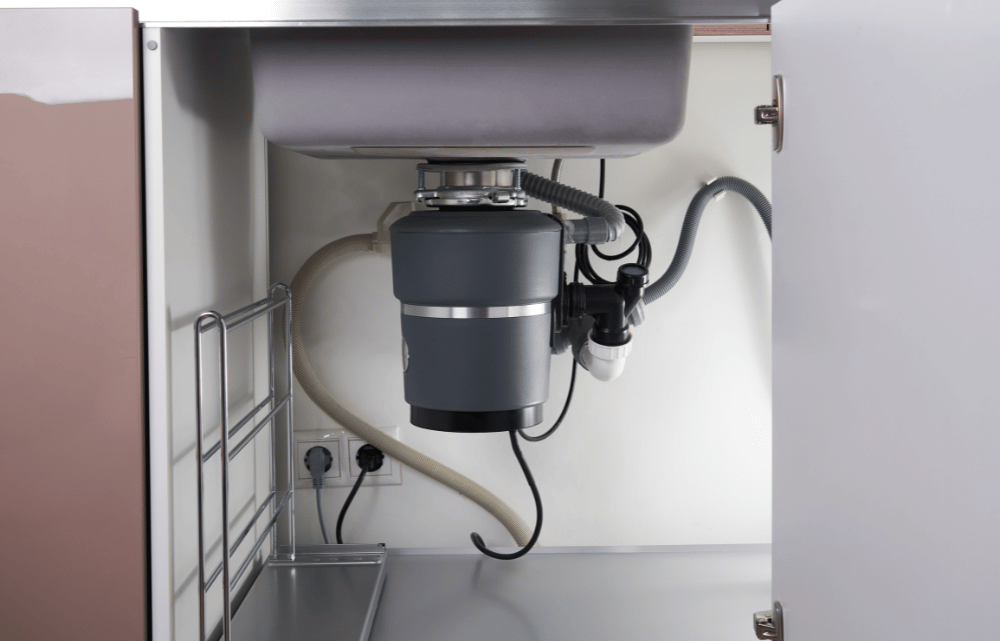 Garbage disposal repair beneath a kitchen sink in Fort Worth, TX